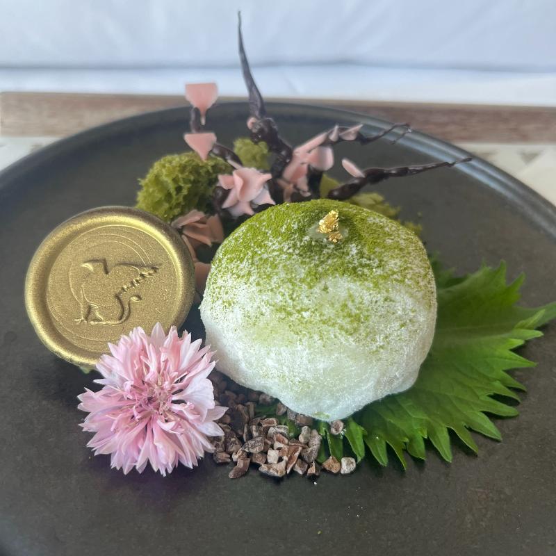 Welcome amenity featuring chocolate sakura branch and matcha-strawberry mochi at JW Marriott Executive Lounge, Vancouver.