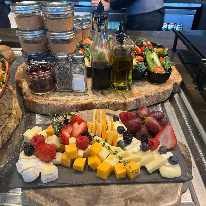Evening charcuterie board with fruit, cheese, and veggie dip cups at JW Marriott Lounge.