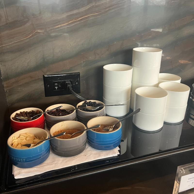 Yogurt and oatmeal bar with customizable toppings at JW Marriott Executive Lounge in Vancouver.