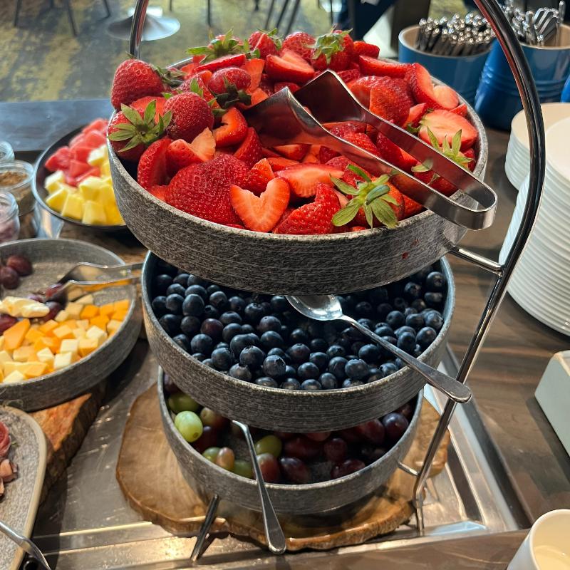 Fresh fruit platter with strawberries, blueberries, grapes, and melon at JW Marriott Vancouver Lounge.