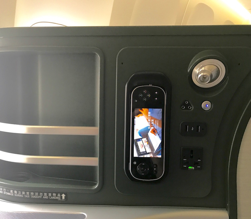 In-Flight Entertainment Remote, Power Source, And Seat Storage